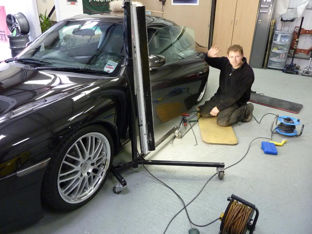 Oliver carrying out a paintless dent repair in the workshop